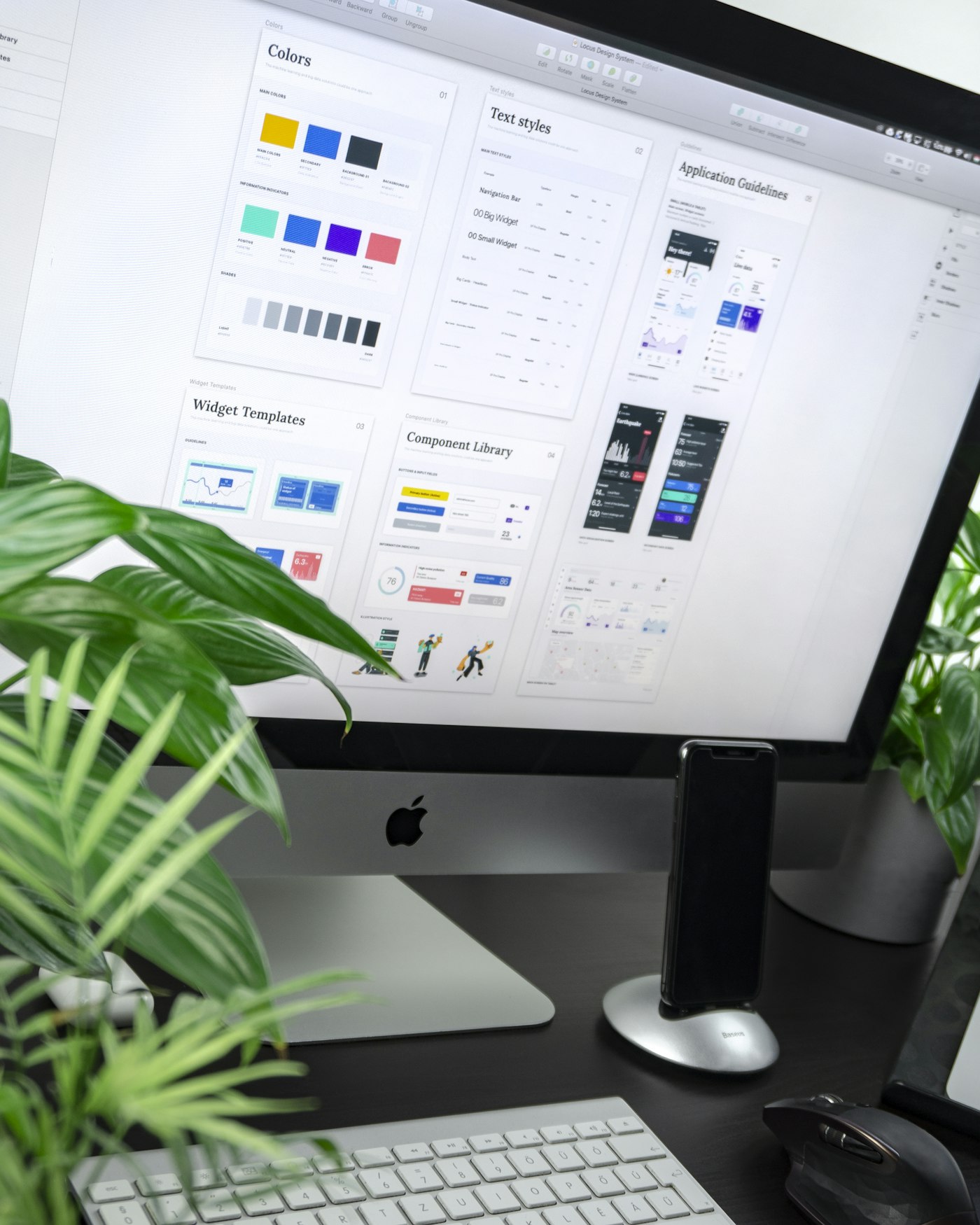 Designer reviewing colourful brand artwork