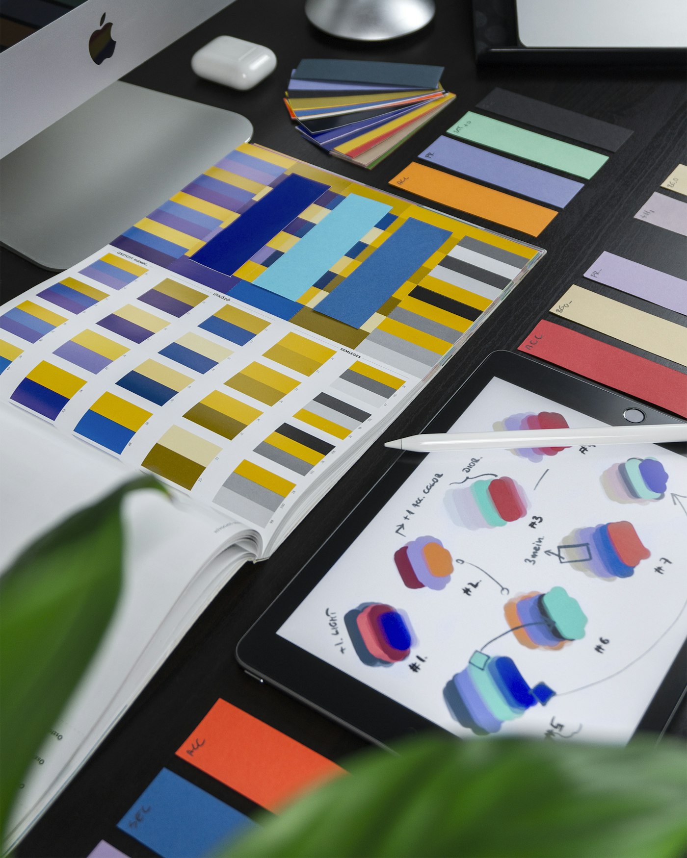 Brand materials and colour studies on a studio desk